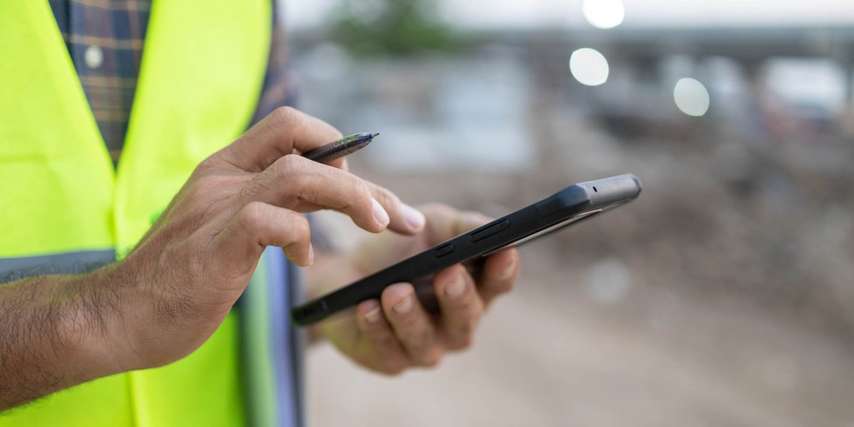 Construction site worker with logistics notifications