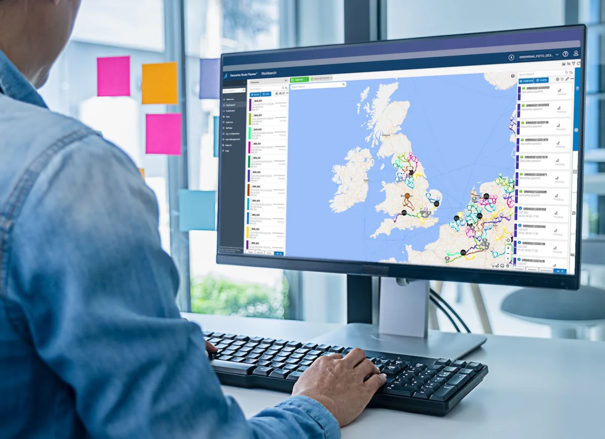 Woman looks at optimised routes on a desktop computer running route optimisation software
